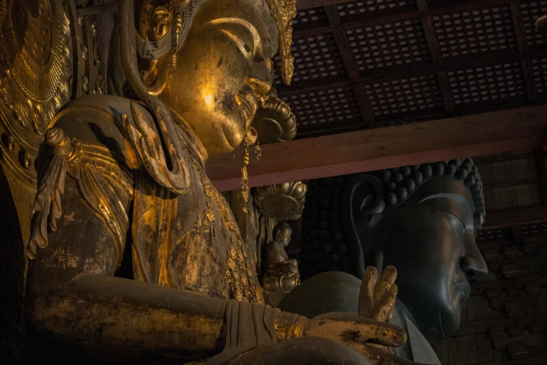 several statues with lights in the dark