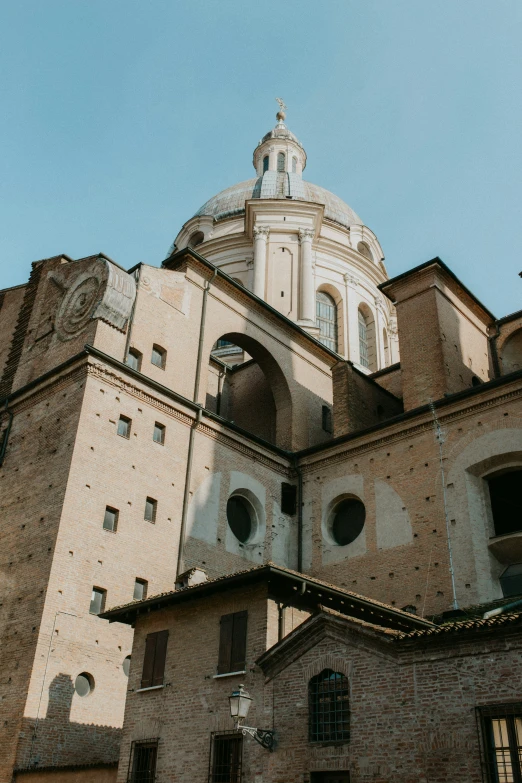 the side of a building with a large white dome on top