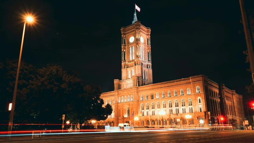 an old building at night with lights going down