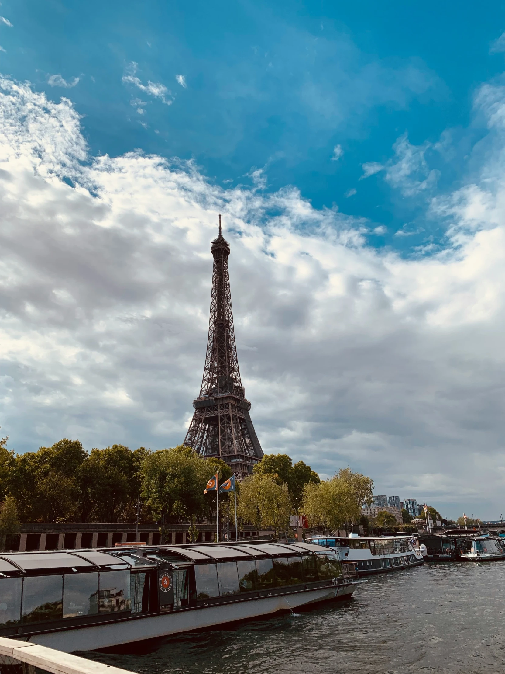 the eiffel tower is shown in the distance near some boats