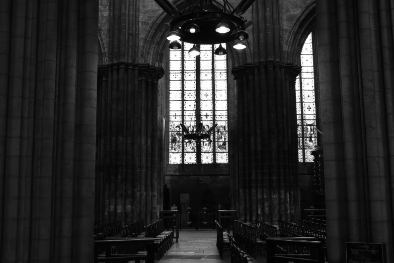 a cathedral has several windows, benches and tables