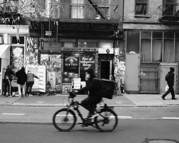 a person riding a bike down a city street