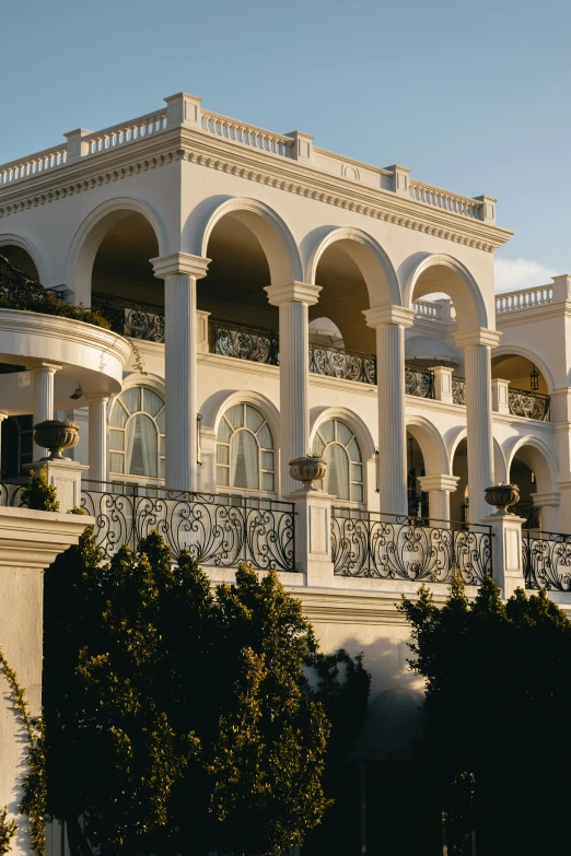 a white mansion with pillars, balconies and a balcony