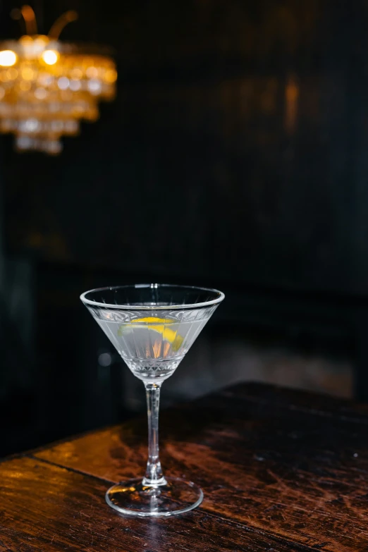 a martini glass filled with a yellow liquid