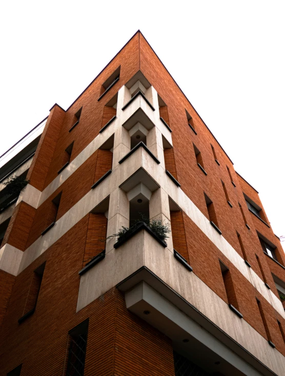 a tall brick building with multiple stories on the sides