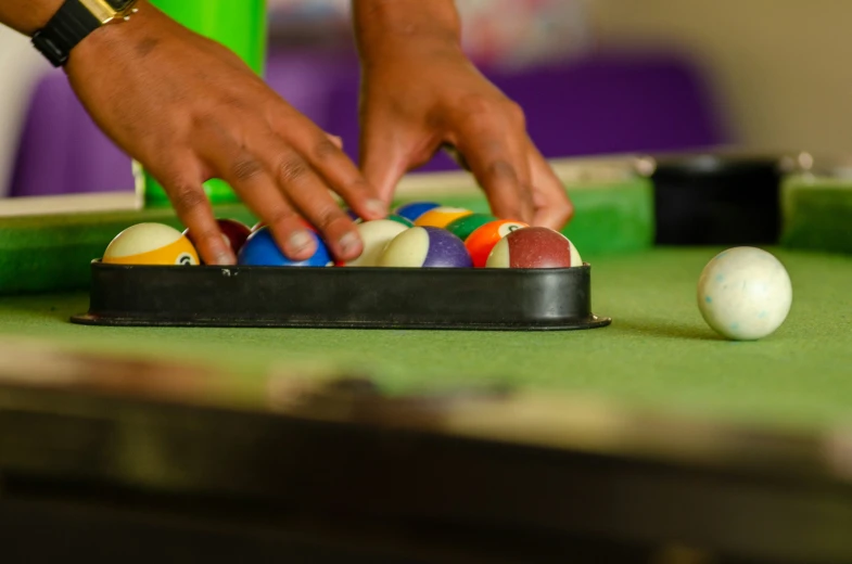 an older man plays pool balls on a bill table