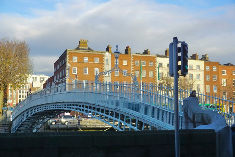 traffic passing under a bridge next to some buildings