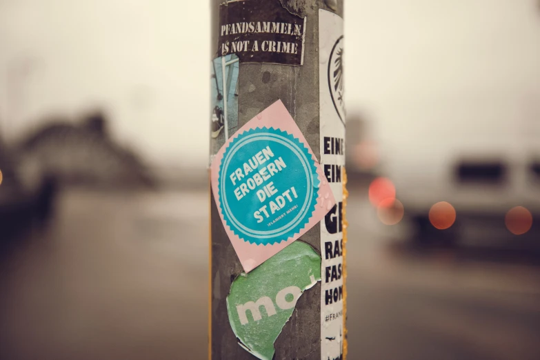 this is a closeup of a pole with the street and car in the background