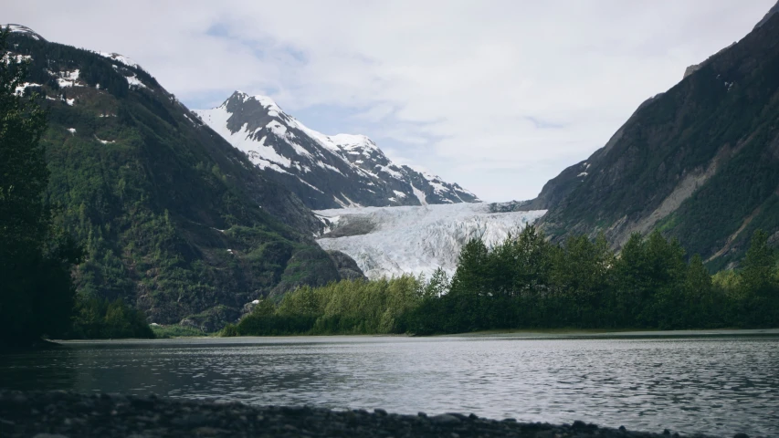 mountains covered in ice and water with trees