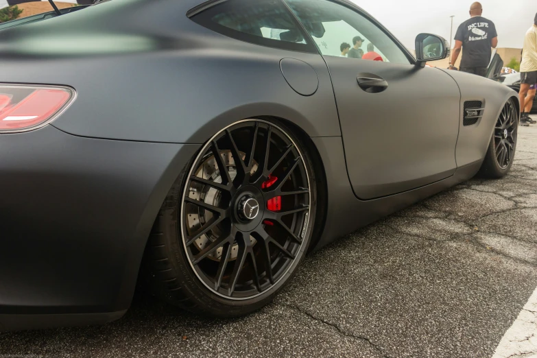 a close up of the rear wheel on a grey sports car