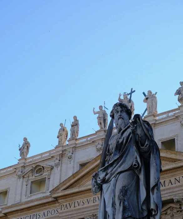 a large statue with a large tree near by