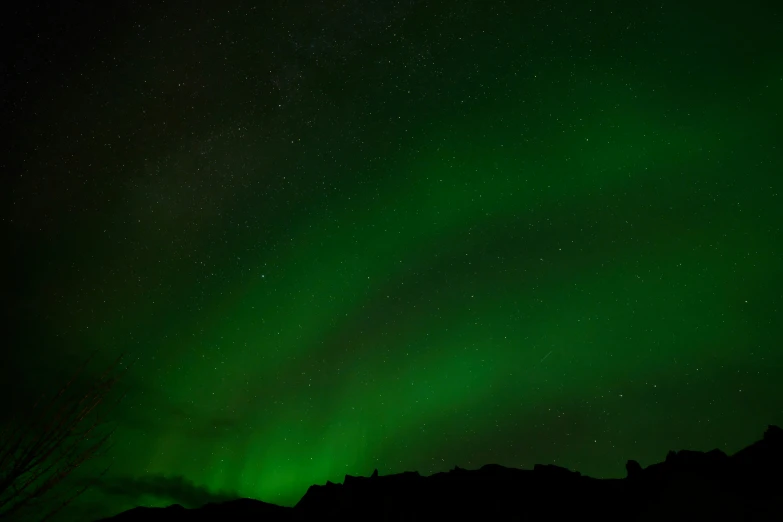 a large green light shines in the sky