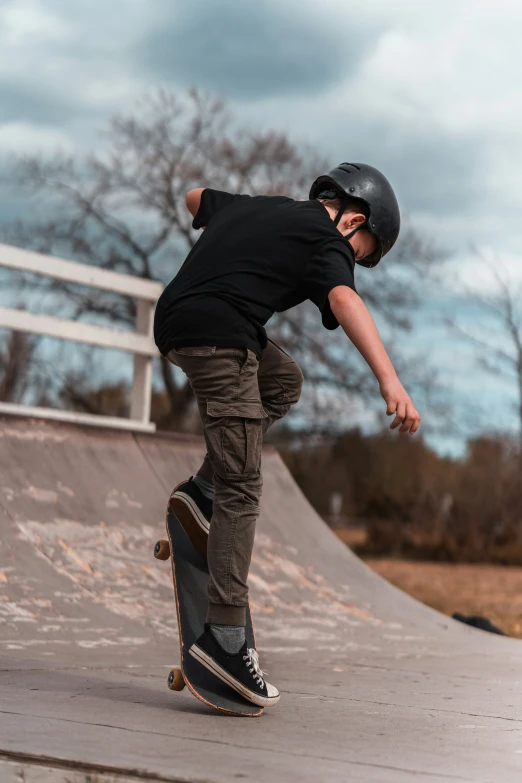 a man skateboarding down the side of a cement ramp