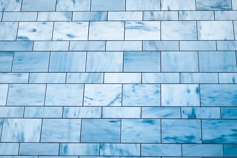 the texture of a tile wall with a blue hue