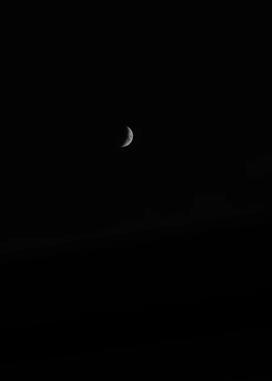 a crescent is visible across a black sky