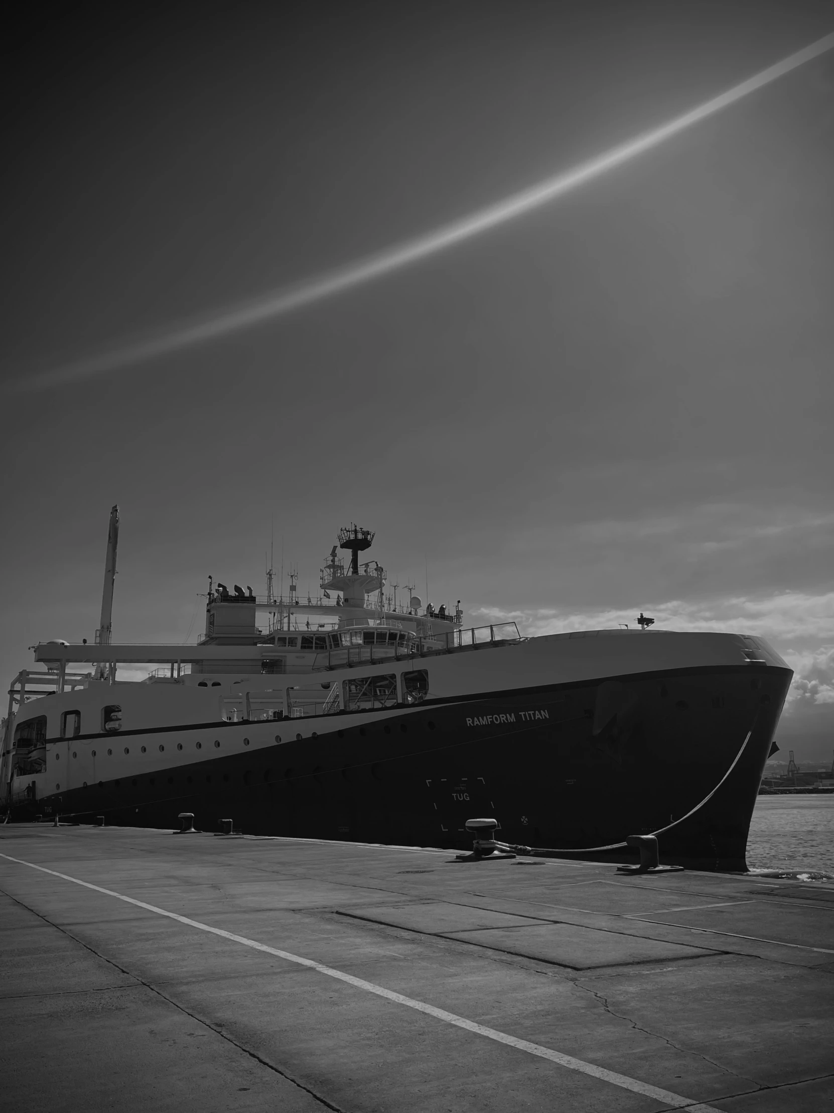 large black and white boat docked at pier