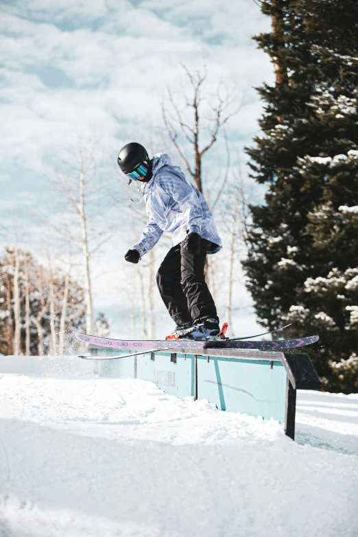 a person riding skis on top of a rail