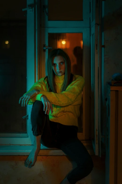 a woman in yellow is sitting outside the door