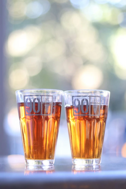 a close up of two cups of beer