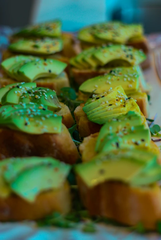 the bread has been covered in various green fruit slices