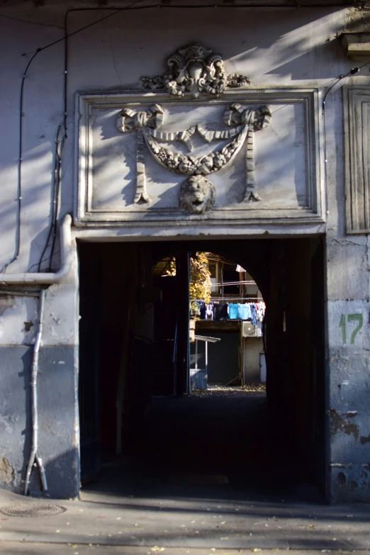 the door to the building is open, revealing a long hallway