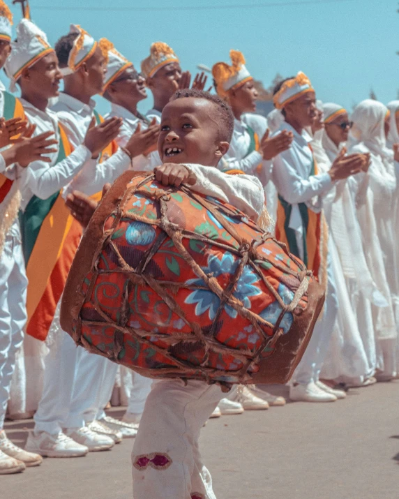 children and men in white uniforms carrying baskets during a parade