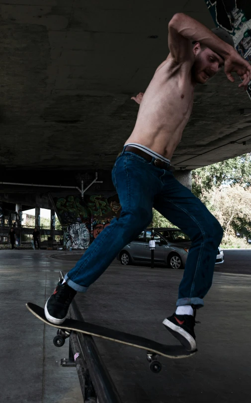 a man riding a skateboard under a bridge