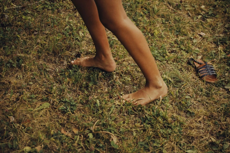 a couple in their shoes walking across the grass