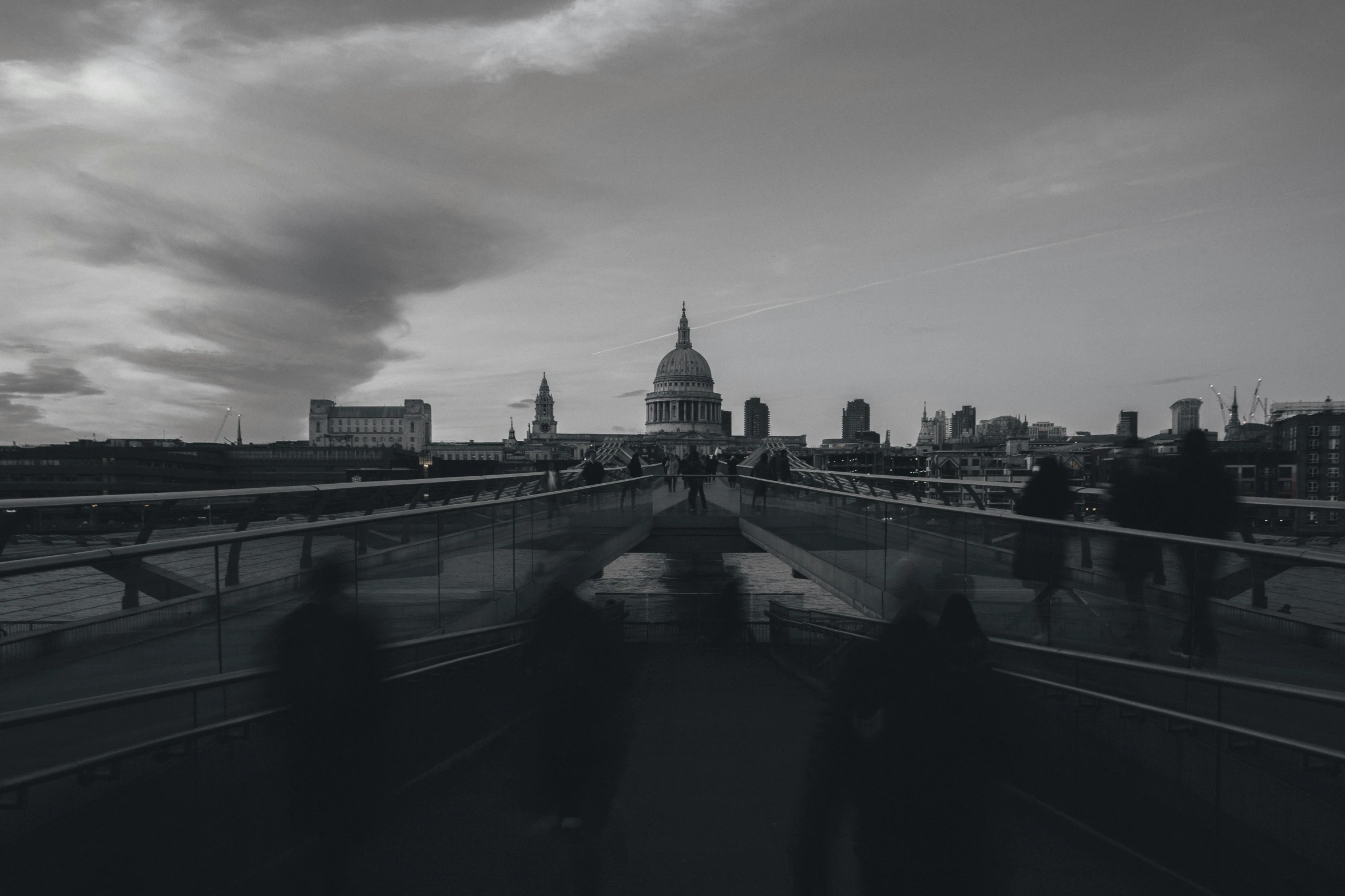 some people are walking across a bridge together