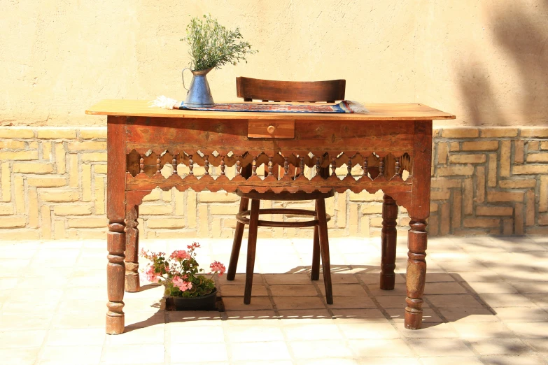 a wooden table with a plant in the middle on top of it