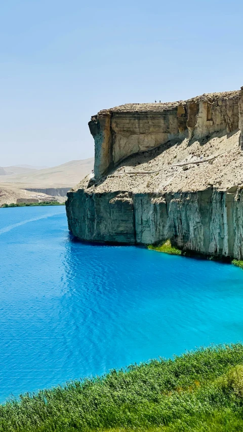 some very pretty blue water by some big mountains