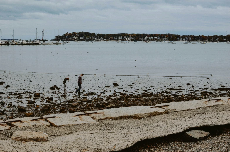 a large body of water that has some people standing around it