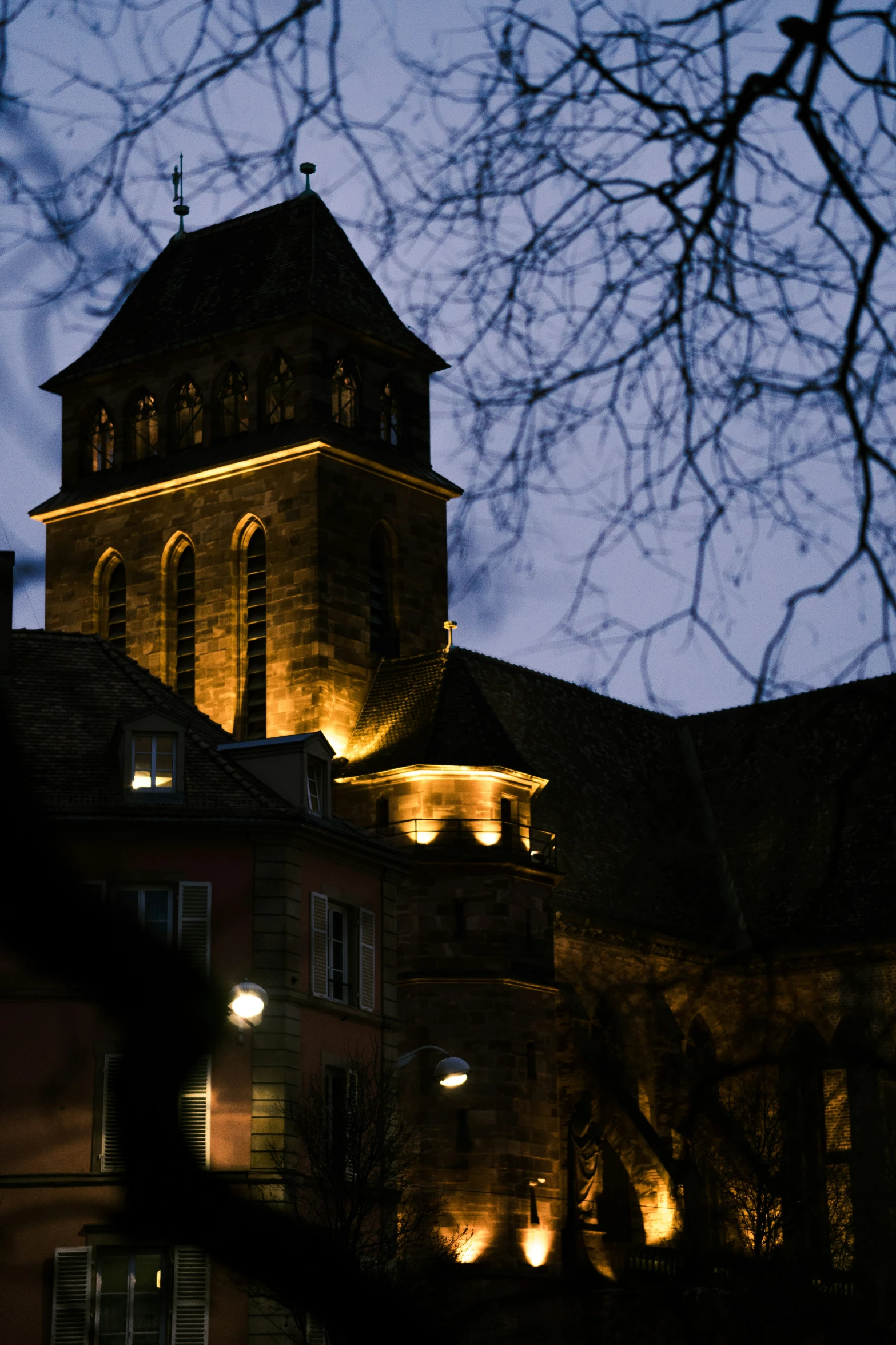 an old brick building that has lights on it