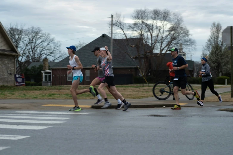 people are running along the road, while others jog by