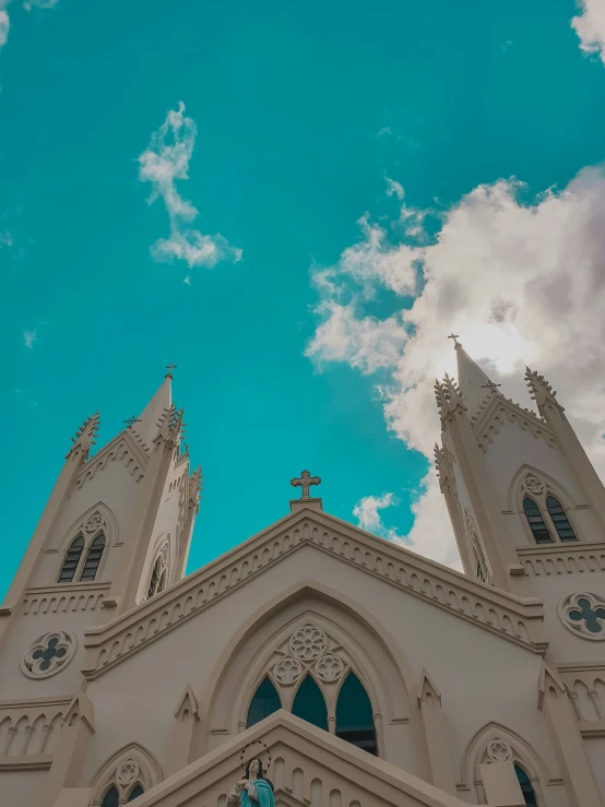 an architectural building under cloudy skies with clouds