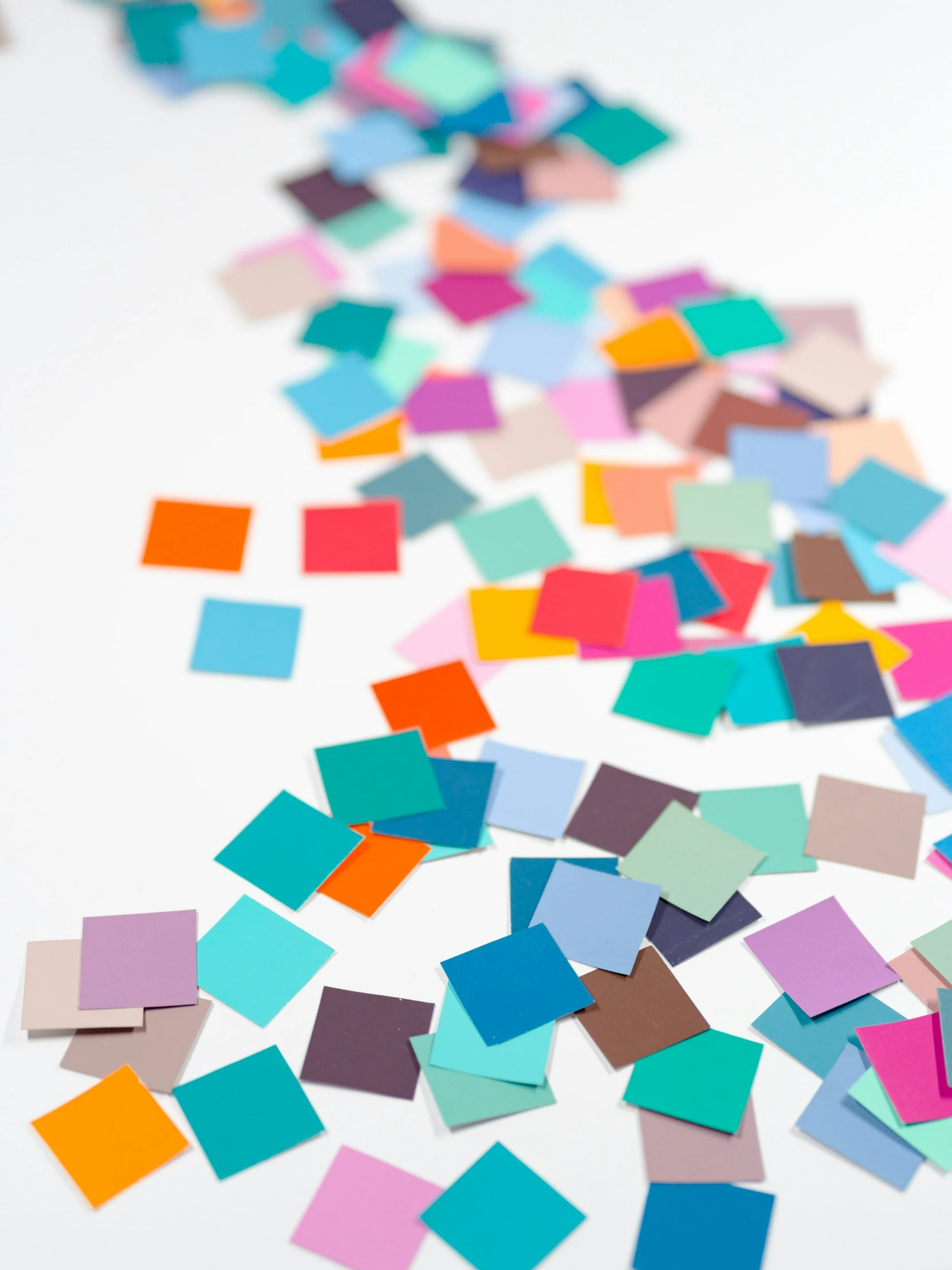 a few small colorful papers scattered over the white surface