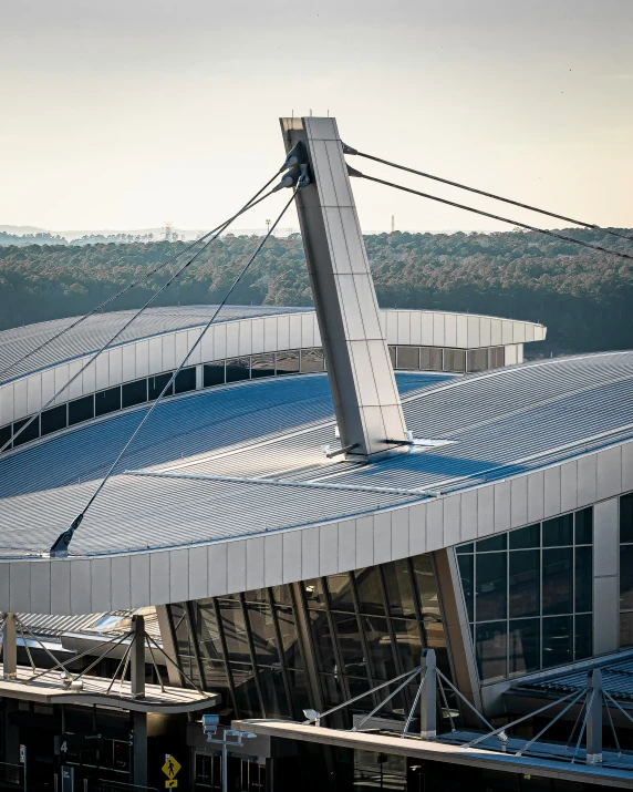 a soccer stadium that has large, curved glass windows