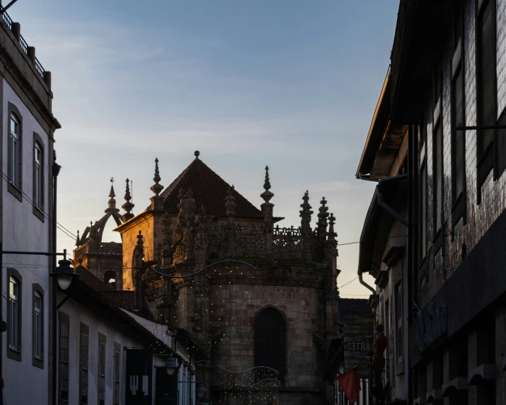 a street with buildings on both sides and a tall clock tower