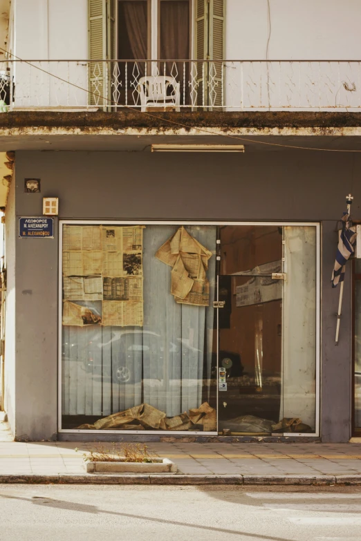 an old looking storefront with torn up items