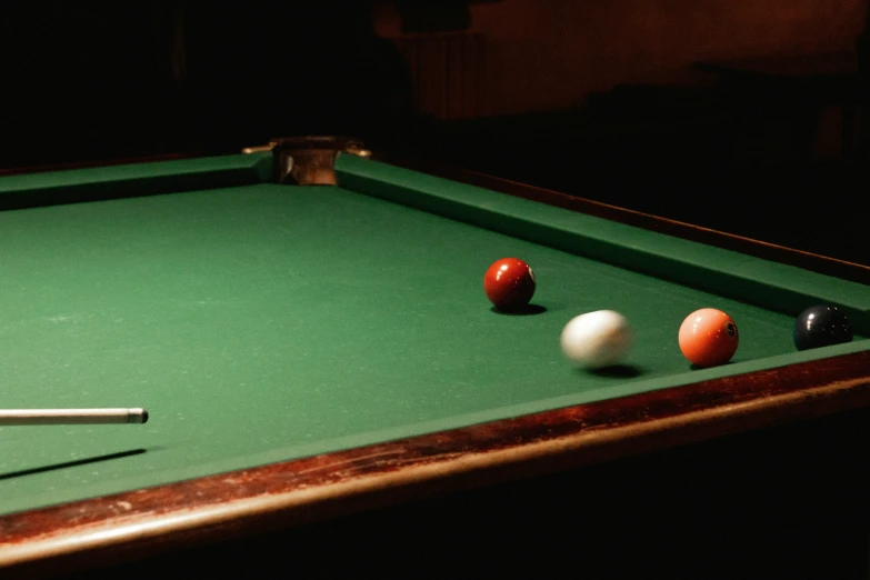 a pool table with three balls and two cues