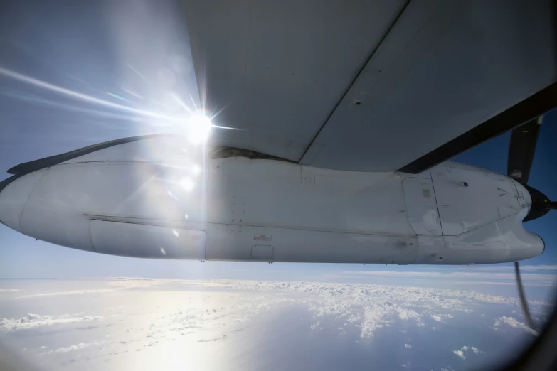 the view out an airplane window shows a bright light