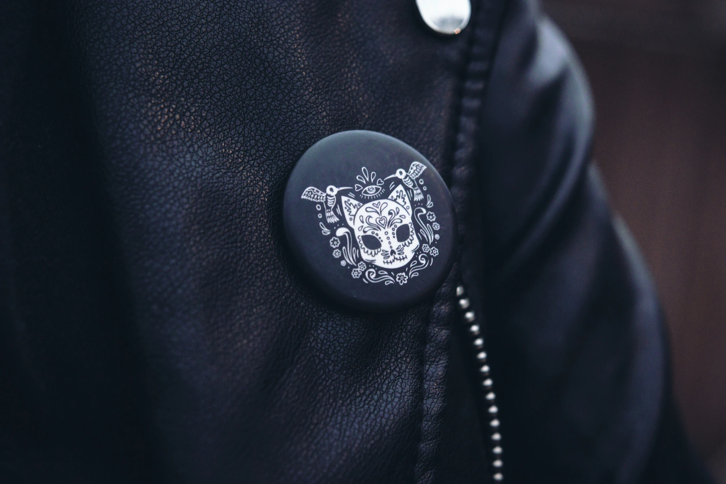 a black jacket with a skull and skeleton embroidered on it