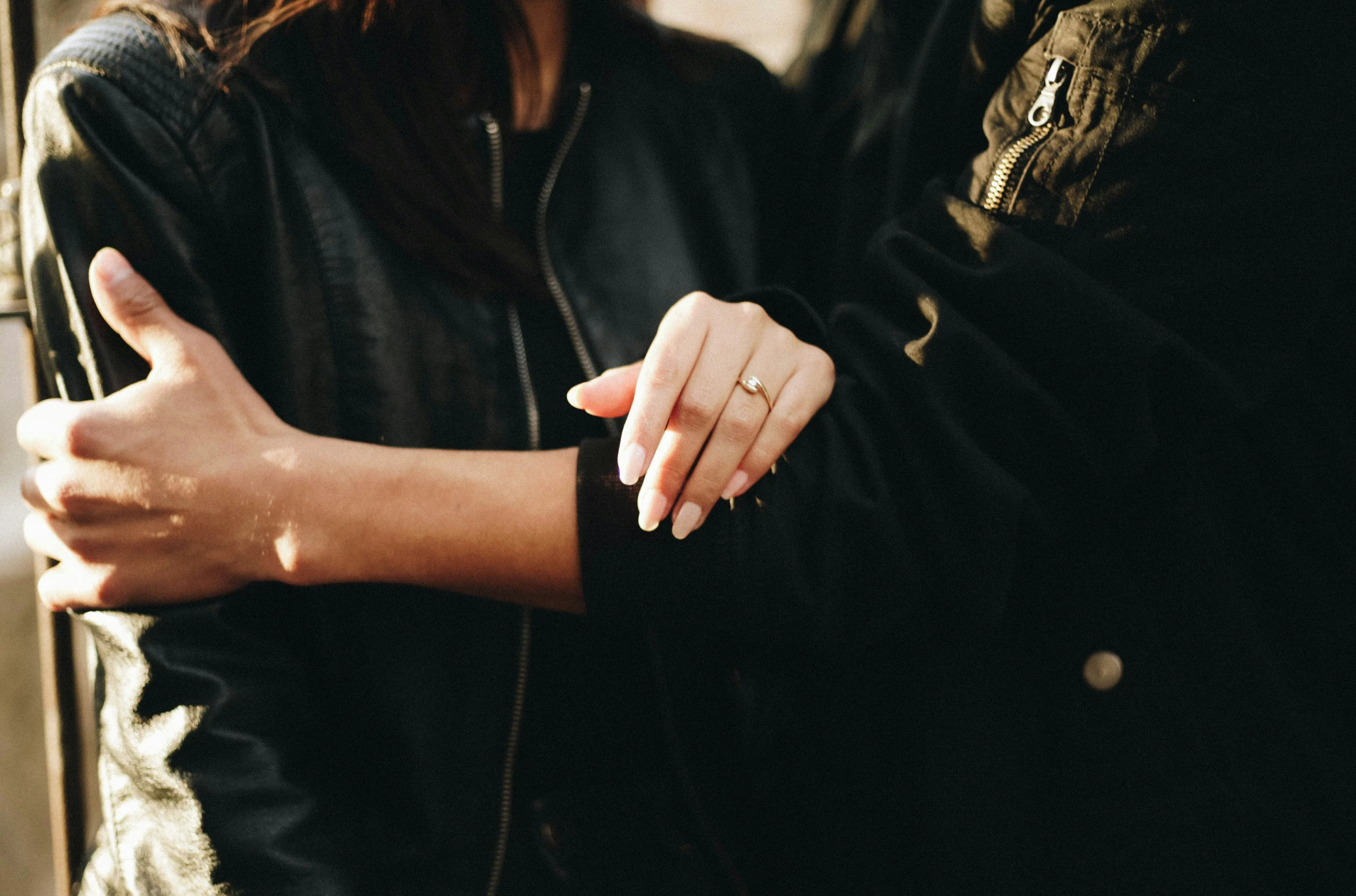 two people are holding hands close together