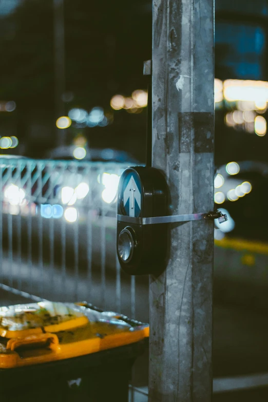 an open street sign next to a pole with cars in the background