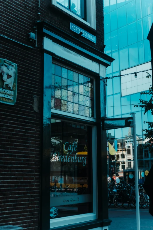 a window on a building next to a sidewalk