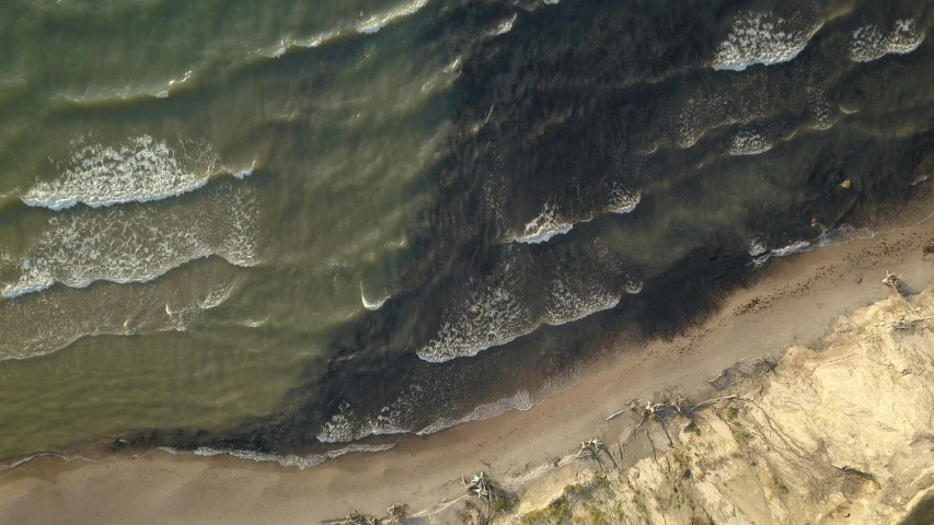 an aerial view of a beach near water