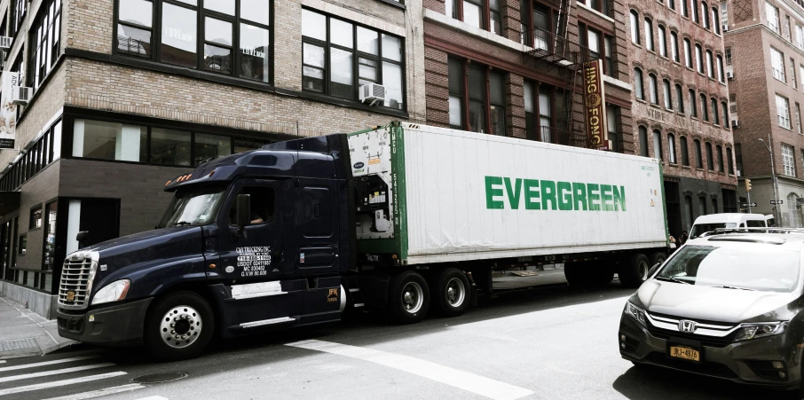 a delivery truck is next to a van on the road