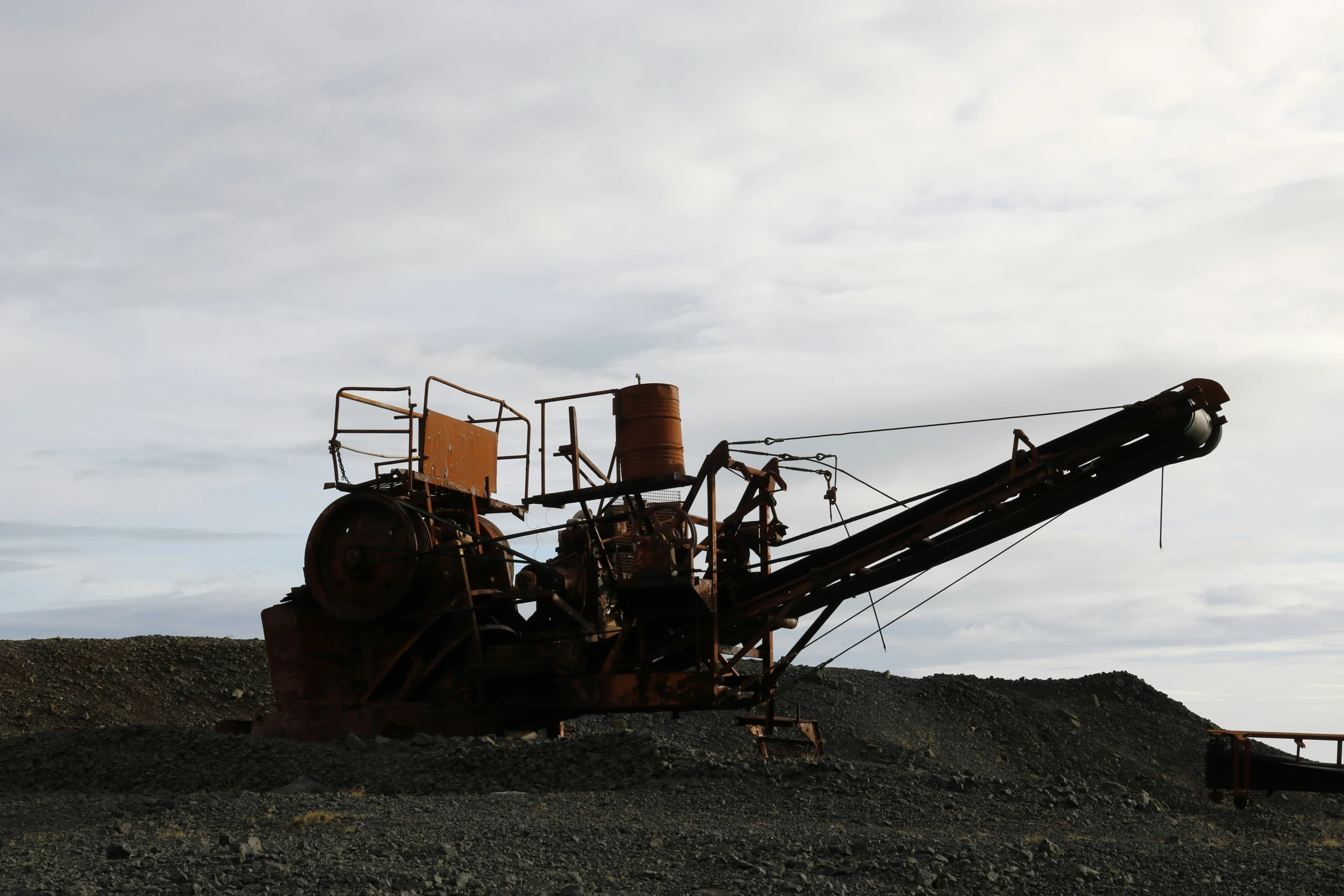 large metal equipment sitting on top of a hill of dirt