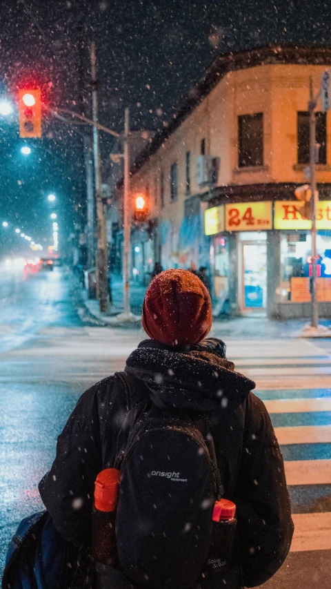 person standing on the side walk of a road