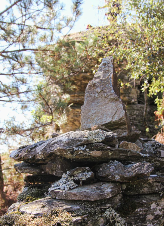 an image of a large rock formation on the hillside